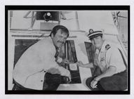 Robert Wagner and a U.S. Coast Guard Auxiliary member on a boat